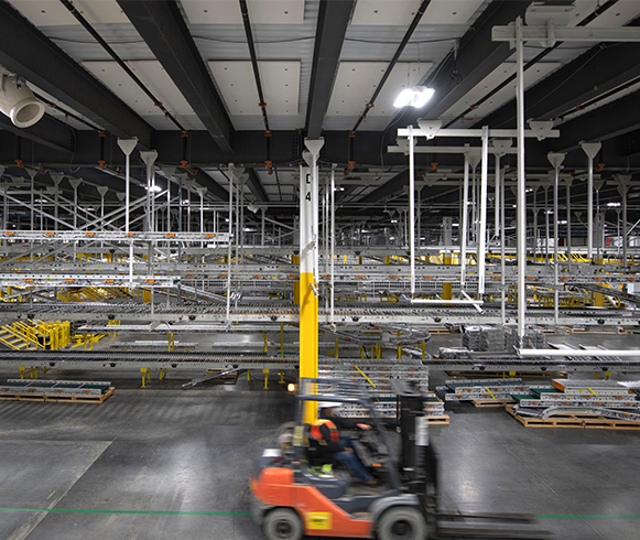 Interior view of Project Diana's Automated Robotics Fulfillment Center showing forklift driving