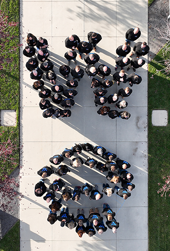 top-down view of employees standing in formation that resembles the word "we"