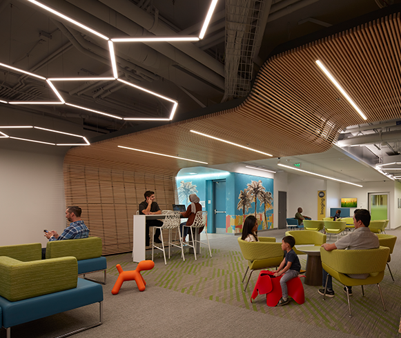 A waiting area with tables and chairs and a wood feature that goes up the wall and covers the ceiling.