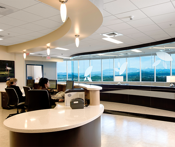 A reception area/nurses station with two staff sitting at computers.