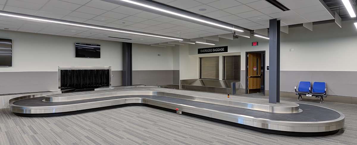Interior view of a baggage claim area at the Terminal Replacement and Provo Airport