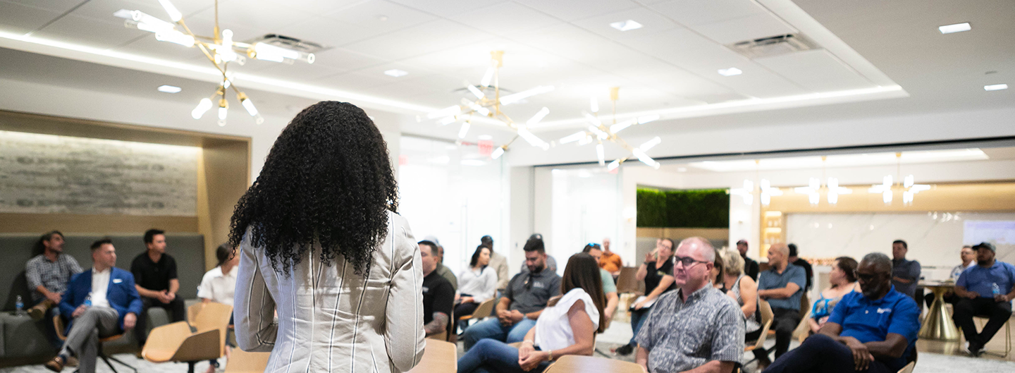 Woman giving speech in front of audience
