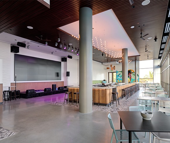 Interior view of open eating area with a stage for entertainment