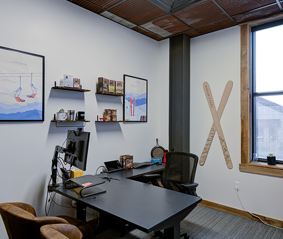 One of the private office spaces with a desk and chairs in Kodiak Cakes office.