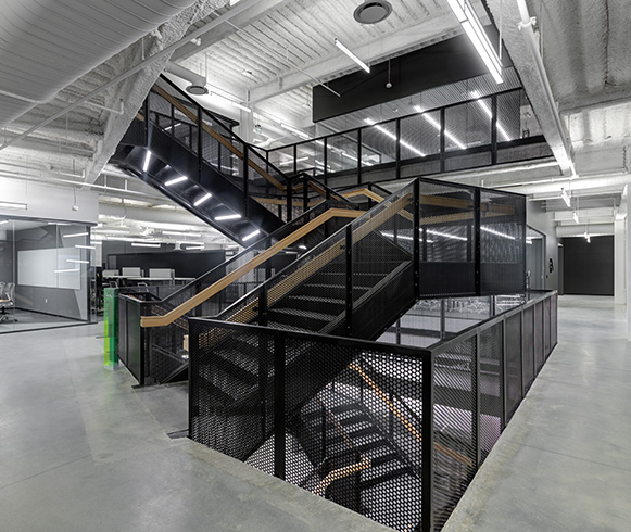 A featured staircase in the center of Pluralsight's office space.