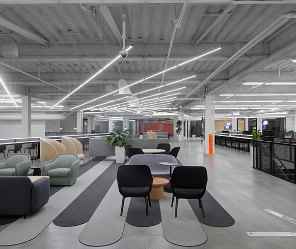 Open seating area with couches and chairs for employees to use.