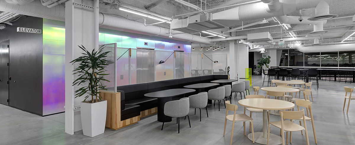 Several small tables and chairs for employees to use.