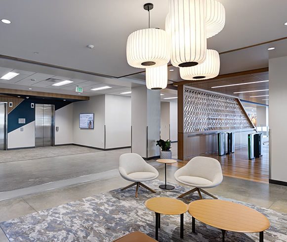 An open area with seating and modern lightning.
