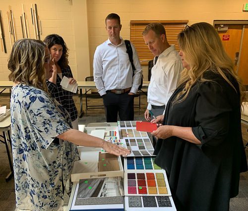 Design charrette showing a client making selections for design with the architect and GC