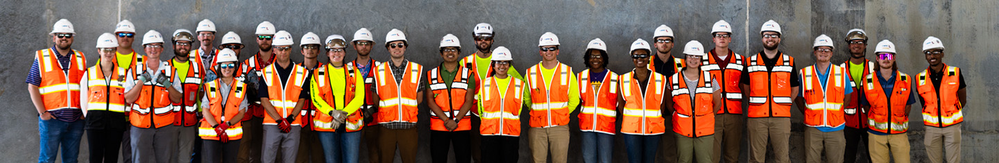 A large group of interns in PPE on site