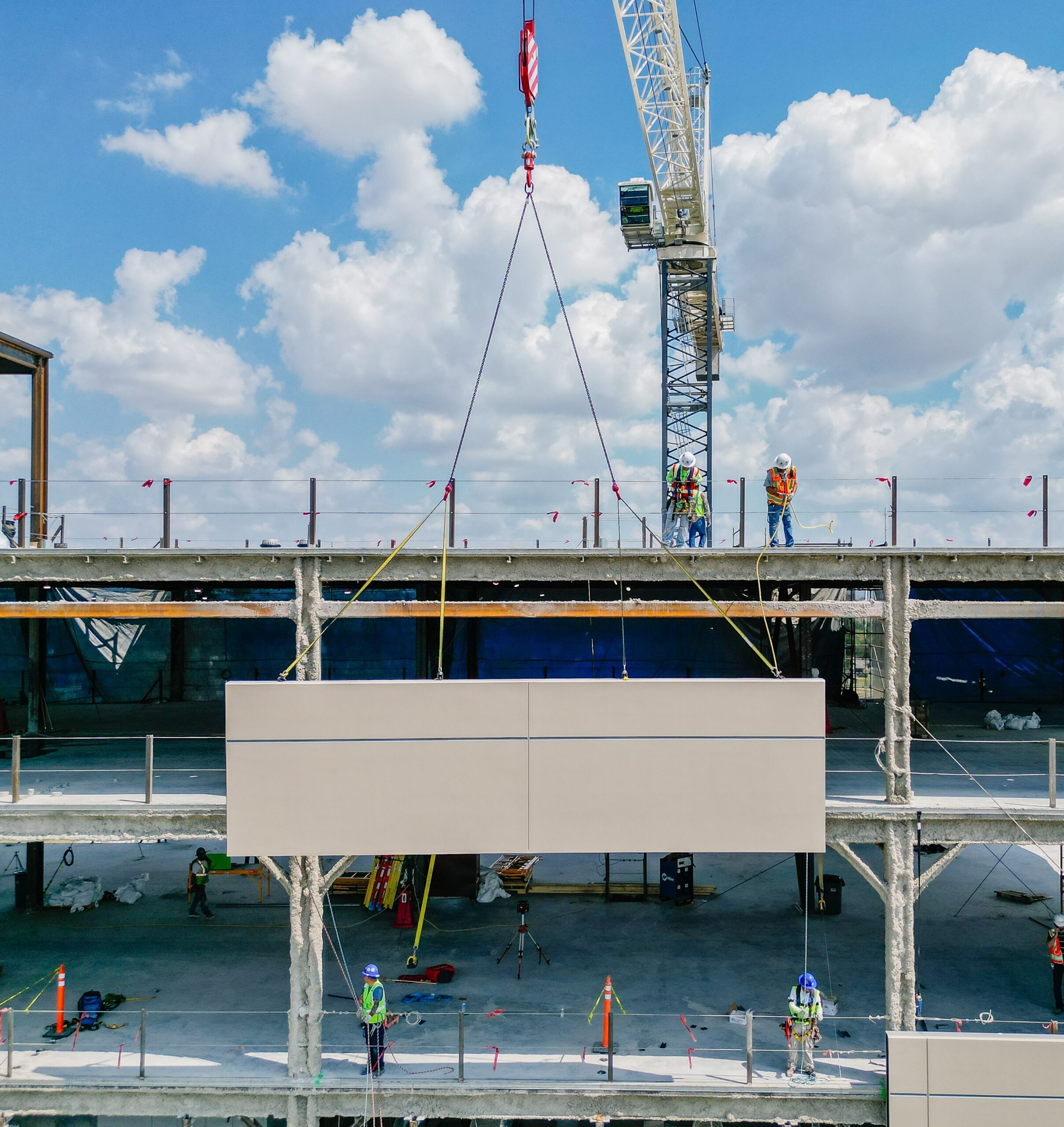 Crane placing prefabricated exterior panel