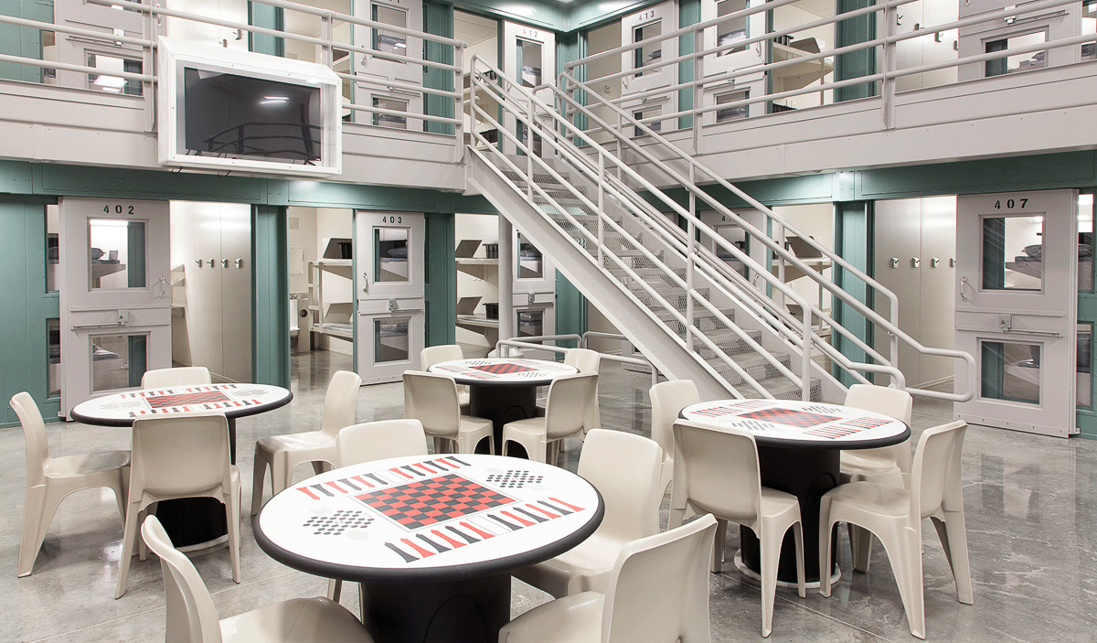 Interior photo of Central Utah Correctional Facility with tables and chairs for inmates