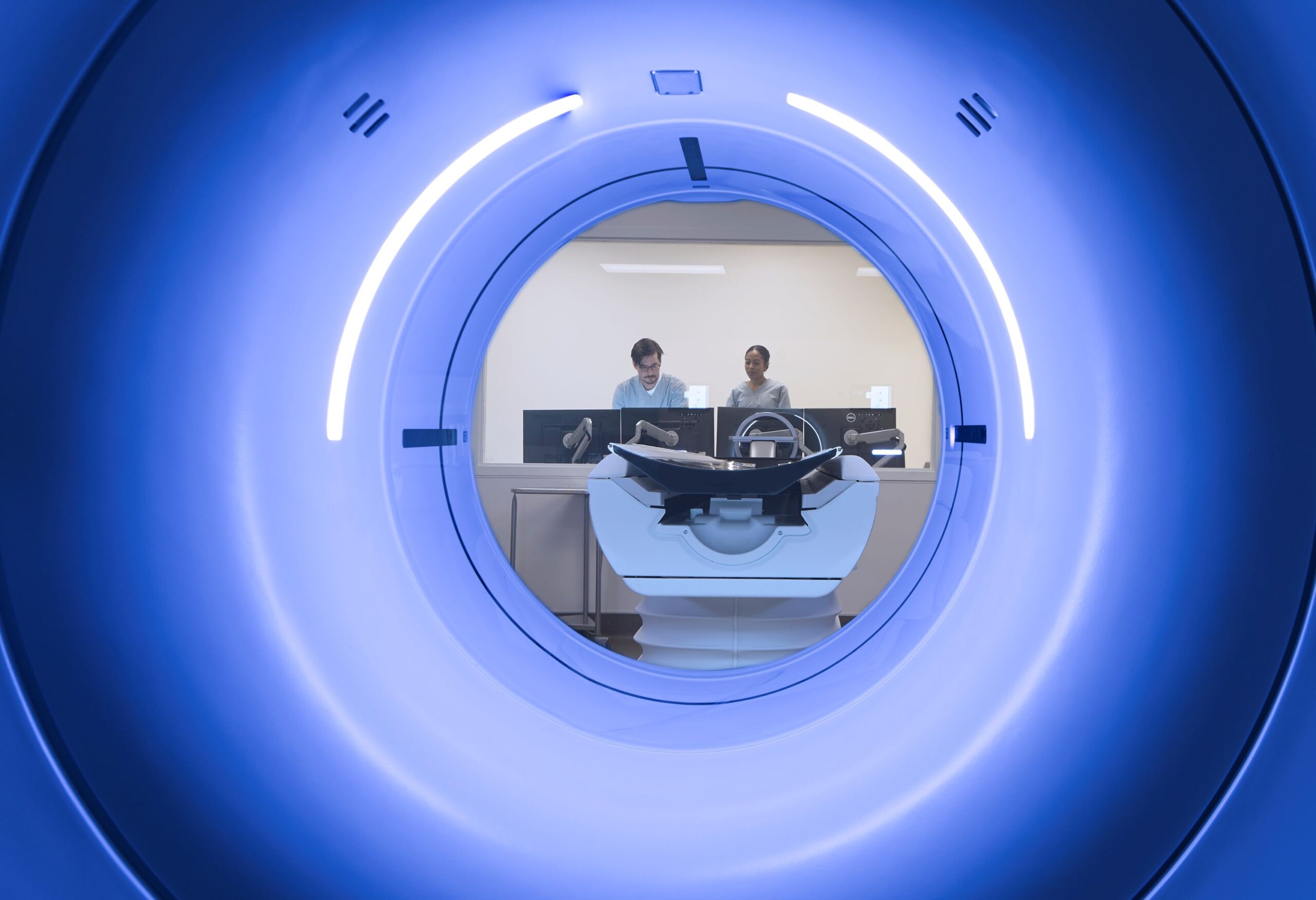 MRI machine with two doctors at a computer p-hero-w-heading__img